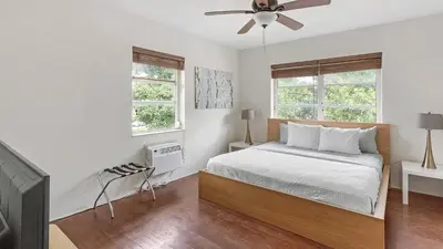 a white bedroom with a bed and two windows at Brickell Tree Apartment Beach 10min Location Shops in Miami