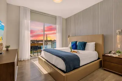 a bedroom with a large bed and a large window at Front Bay View Terrace Amazing Pool in Hollywood