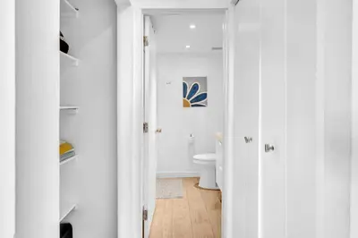 a white bathroom with a toilet in a room at Deluxe modern 1 bedroom in south beach in Miami Beach