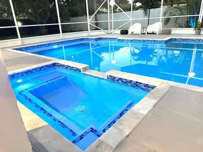 a swimming pool with blue water in a building at Home in Miami in Miami