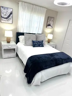 a bedroom with a large bed and two night stands at Home in Miami in Miami
