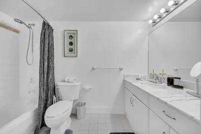a white bathroom with a toilet and a shower at Central ocean view 3 bedrooms in Miami W Parking in Miami