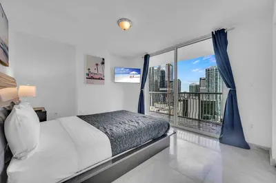 a bedroom with a bed and a large window at Iconic High floor 3 bedrooms in the heart of Miami in Miami