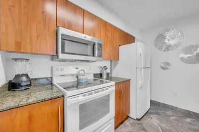 a kitchen with a white stove and a microwave at Iconic High floor 3 bedrooms in the heart of Miami in Miami