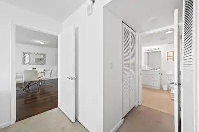 a room with white walls and a kitchen with a table at Superb unit, centrally located with parking in Miami