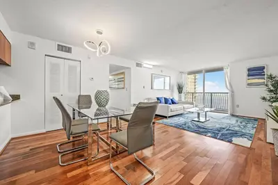 a living room with a table and chairs and a couch at Spacious Ocean view unit in the heart of Brickell in Miami