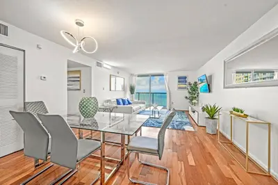 a dining room with a glass table and chairs at Spacious Ocean view unit in the heart of Brickell in Miami