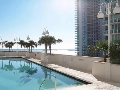 a swimming pool with a view of the ocean at Spacious Ocean view unit in the heart of Brickell in Miami