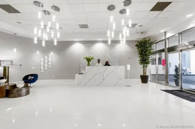 two people sitting at a counter in an office lobby at Ocean view 35th floor, in the heart of Miami in Miami