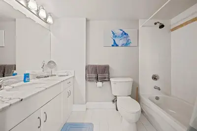 a white bathroom with a toilet and a sink and a tub at Ocean view 35th floor, in the heart of Miami in Miami