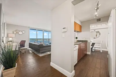 a kitchen and living room with a couch and a table at Ocean view 35th floor, in the heart of Miami in Miami