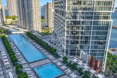 an aerial view of a building with two pools at Emblematic unit at Icon in the heart of Brickell in Miami