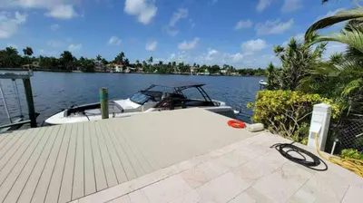 a boat is docked at a dock on the water at Hollywood Luxurious Waterfall Villa with Incredible views in Hollywood