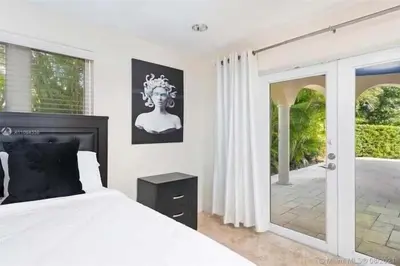 a bedroom with a large bed and a door to a patio at Hollywood Luxurious Waterfall Villa with Incredible views in Hollywood