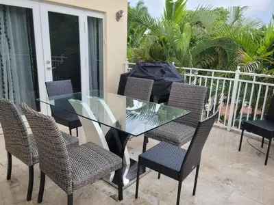a glass table and chairs on a balcony at Hollywood Luxurious Waterfall Villa with Incredible views in Hollywood