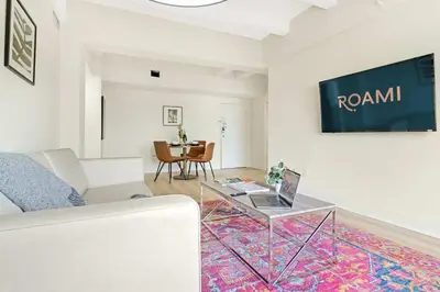 a living room with a couch and a glass table at Roami at The Alamac in Miami Beach