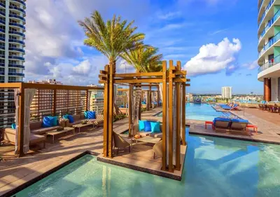 a pool on the roof of a building with a resort at Insane Ocean View Balcony Beachfront Resort Pool in Hollywood