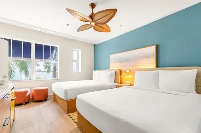 a bedroom with two beds and a ceiling fan at Aloha Fridays in Miami Beach