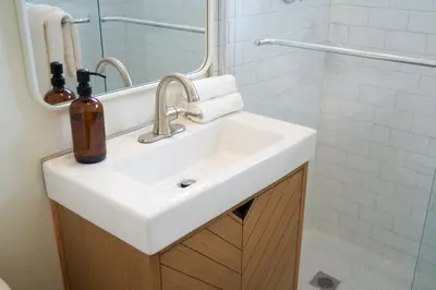 a bathroom with a white sink and a mirror at Aloha Fridays in Miami Beach