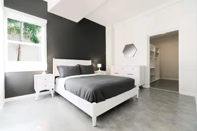 a white bedroom with a bed and a window at Franklin Suites South Beach in Miami Beach