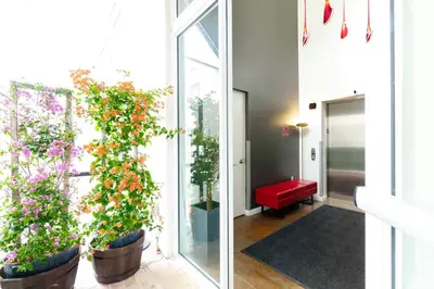 a room with potted plants and a red bench at Franklin Suites South Beach in Miami Beach