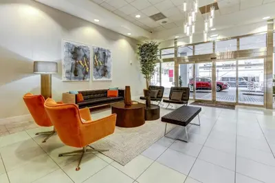 a living room with a couch and a table and chairs at 2BR Penthouse with Unbeatable Water Views and Parking in Miami