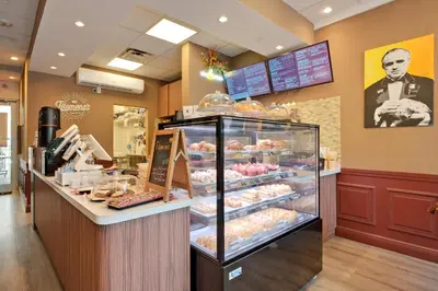 a bakery with a display case filled with pastries at MIAMI Collins Beach Apartments in Sunny Isles Beach