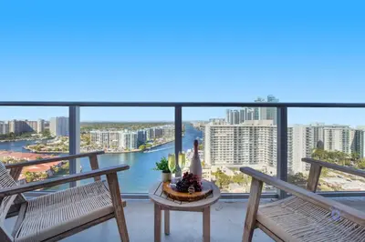 a balcony with two chairs and a table at High Floor with Stunning Views Amazing Pools in Hollywood