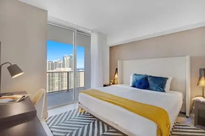 a bedroom with a large bed and a large window at High Floor with Stunning Views Amazing Pools in Hollywood