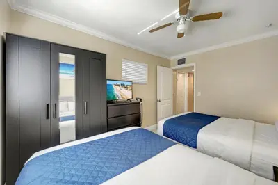a bedroom with two beds and a flat screen tv at Great Location 5BR Heated Pool near Hollywood Beach in Hollywood