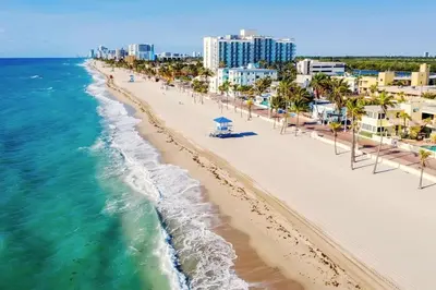 an aerial view of a beach with palm trees and buildings at Great Location 5BR Heated Pool near Hollywood Beach in Hollywood