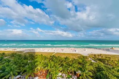 an aerial view of a beach with palm trees and the ocean at Oceanfront Private Residence at South Beach - 828 in Miami Beach