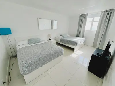 a bedroom with two beds and a television in it at Miami Hollywood Gorgeous 2BD Awesome Ocean View in Hollywood