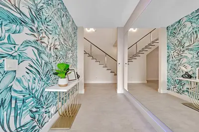 a hallway with stairs and a mural of plants at Your Dream Home in Coral Ridge in Fort Lauderdale
