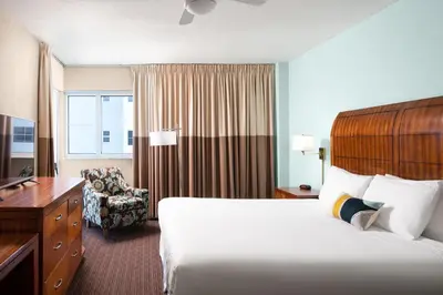a hotel room with a bed and a chair at Sherry Frontenac Oceanfront in Miami Beach