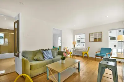 a living room with a couch and a table at Seaheights Villa in Miami Beach