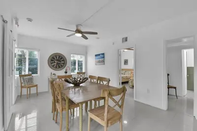 a dining room and living room with a table and chairs at Seaheights Villa in Miami Beach