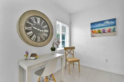 a white room with a large clock on the wall at Seaheights Villa in Miami Beach