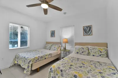 a bedroom with two beds and a ceiling fan at Seaheights Villa in Miami Beach