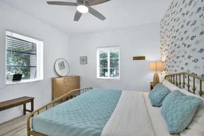a bedroom with a bed and a ceiling fan at Seaheights Villa in Miami Beach