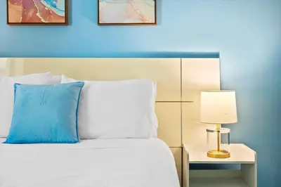 a bedroom with a bed with a blue wall at Luxury House 4 beds heated Pool w Jaccuzzi in North Bay Village