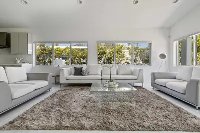 a living room with white couches and a rug at Luxury House 4 beds heated Pool w Jaccuzzi in North Bay Village