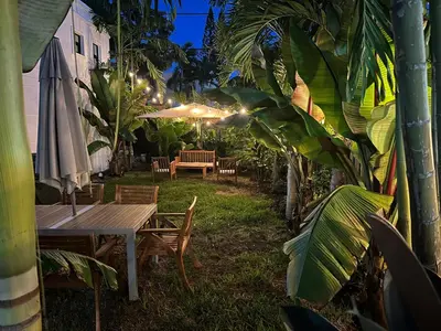a patio with a table and chairs and an umbrella at Villa Verde Miami in Miami