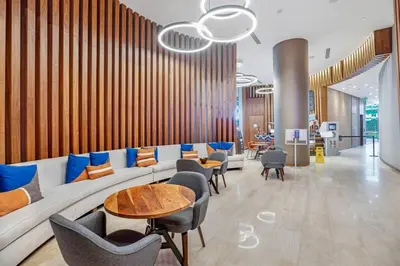 a lobby with a couch and tables and chairs at Beachfront Condo with Mesmerizing Views in Hollywood