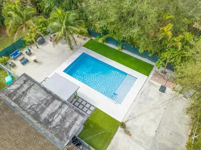 an overhead view of a swimming pool and palm trees at Farmhouse Miami in Miami