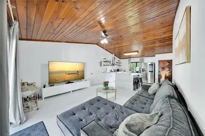 a living room with a couch and a tv at Farmhouse Miami in Miami