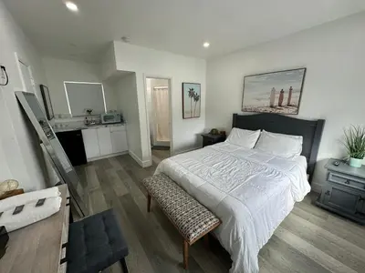 a bedroom with a large bed and a bathroom at Rainbow Motel Miami in Miami