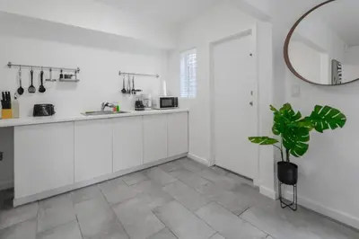 a kitchen with white cabinets and a potted plant at Great Apartment 2 BR near the beach in Miami