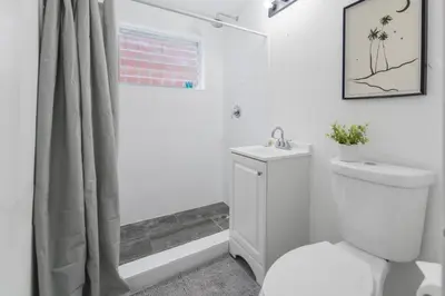 a white bathroom with a toilet and a shower at Great Apartment 2 BR near the beach in Miami
