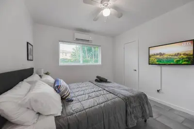 a bedroom with a bed and a tv on the wall at Great Apartment 2 BR near the beach in Miami
